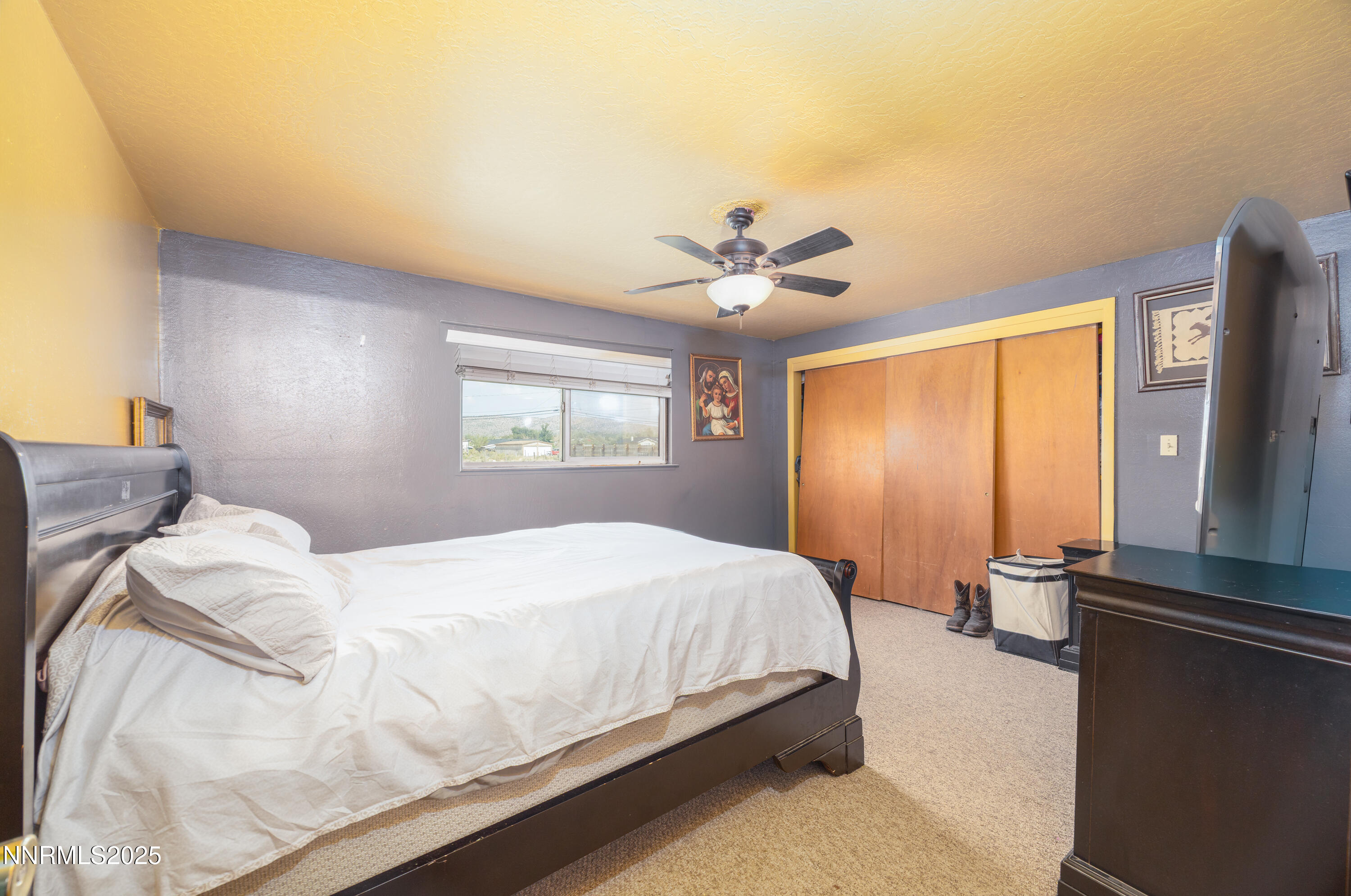 11605 Lemmon Drive Reno, NV 89506 - Photo 10 of 18 a bedroom with a large bed and a chandelier