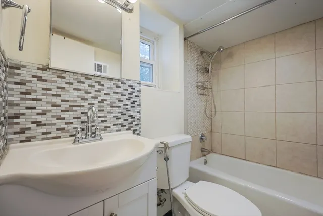 a bathroom with a bathtub and toilet