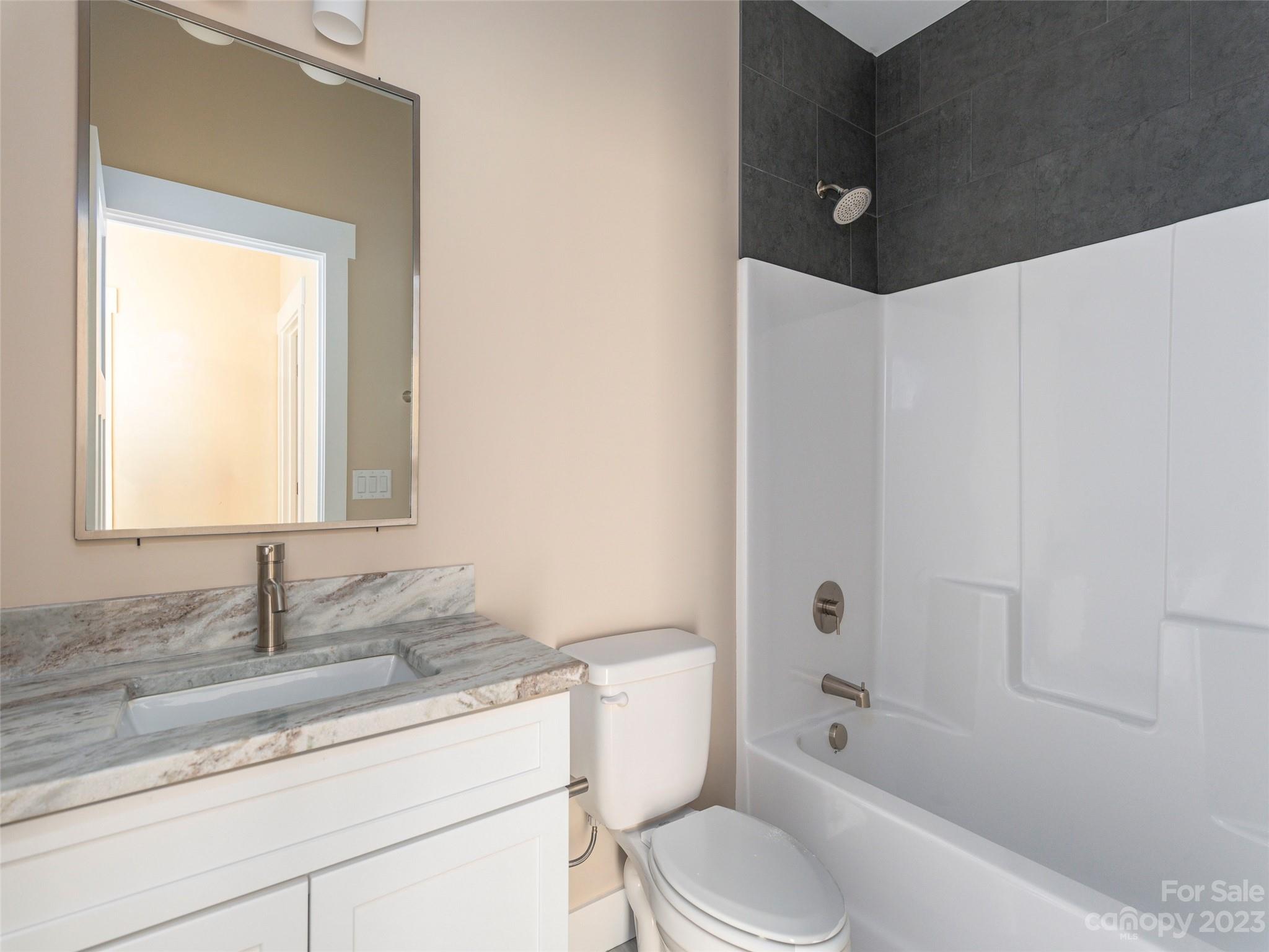 25 Heartleaf Circle Arden, NC 28704 - Photo 15 of 16 a bathroom with a granite countertop sink toilet and shower