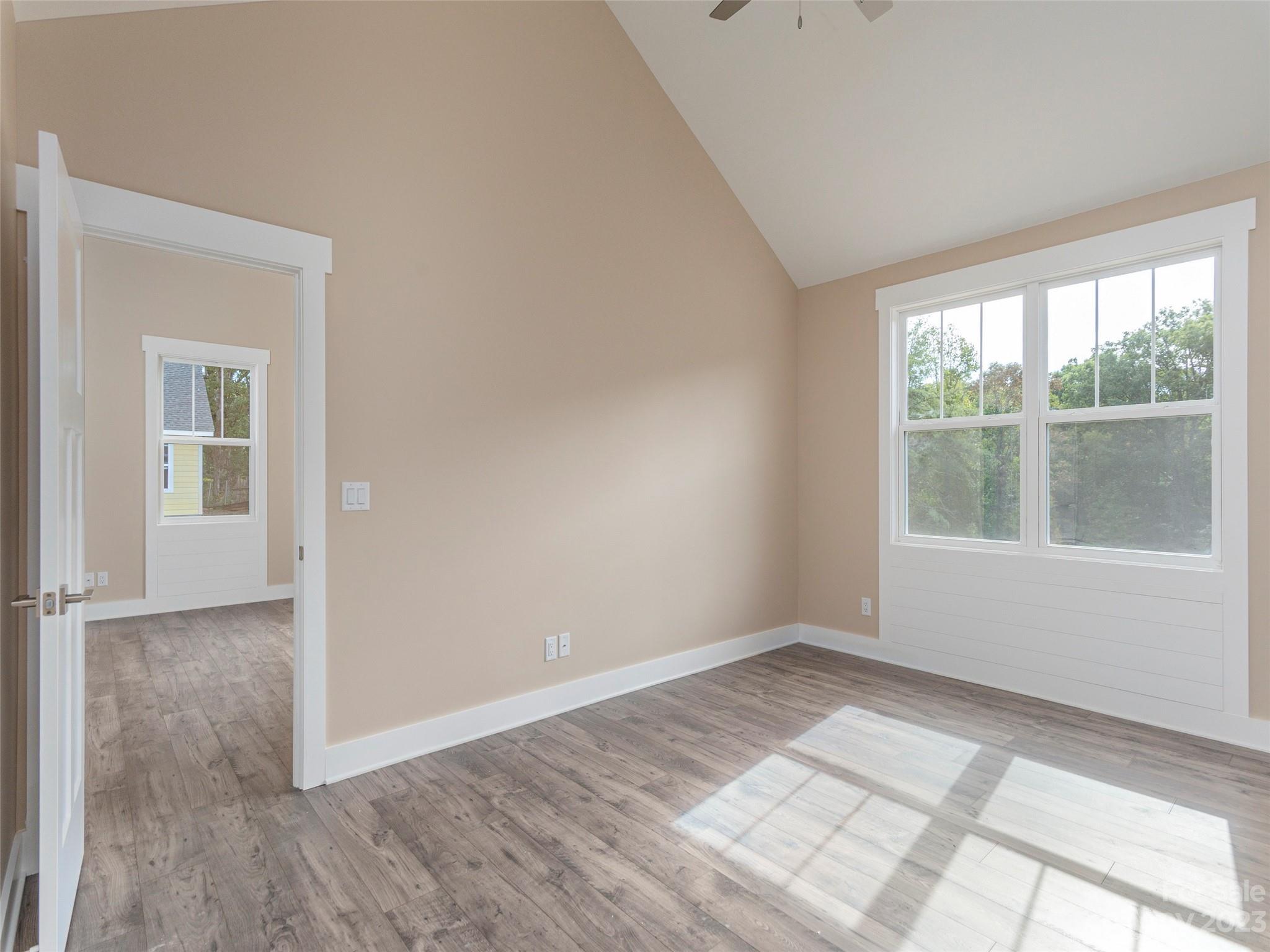 25 Heartleaf Circle Arden, NC 28704 - Photo 3 of 16 an empty room with wooden floor and windows