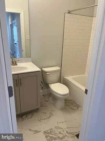a bathroom with a toilet a sink and a shower