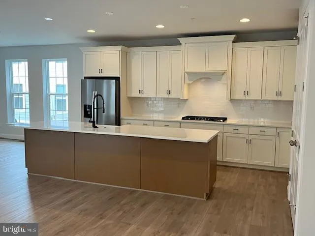 a kitchen with a refrigerator and a sink