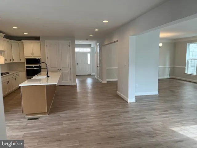 a kitchen with stainless steel appliances a refrigerator sink and cabinets