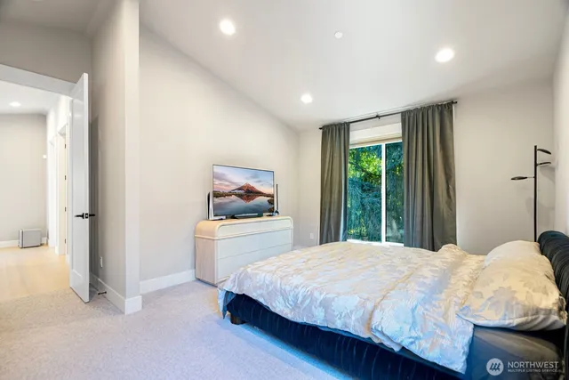 a bedroom with a large bed and a window