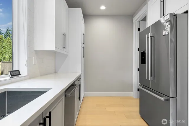 a kitchen with stainless steel appliances a refrigerator and a sink