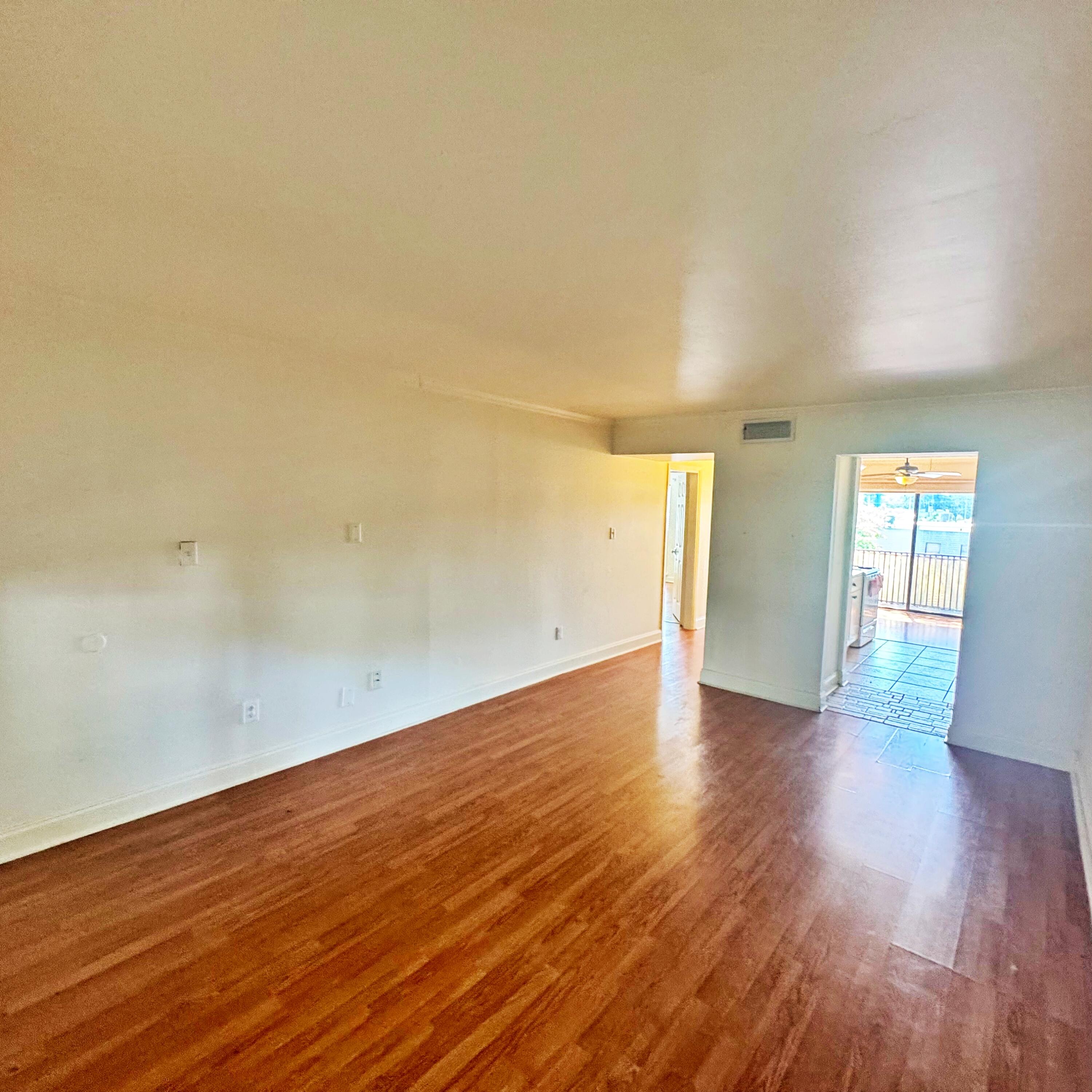 210 Pelham Road, Unit 215B Fort Walton Beach, FL 32547 - Photo 10 of 23 a view of empty room with wooden floor and fan