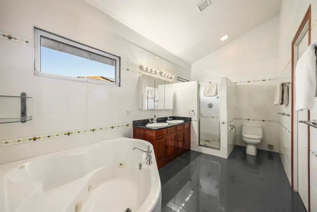 a spacious bathroom with a bathtub sink and toilet