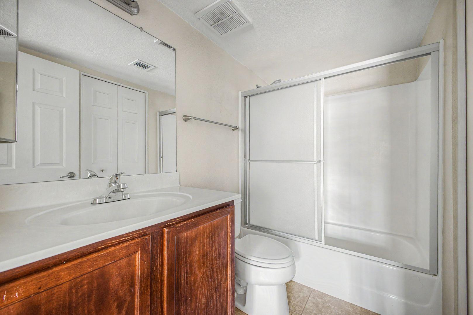 1720 East Thunderbird Road, Unit 1086 Phoenix, AZ 85022 - Photo 16 of 32 a bathroom with a sink a toilet and shower