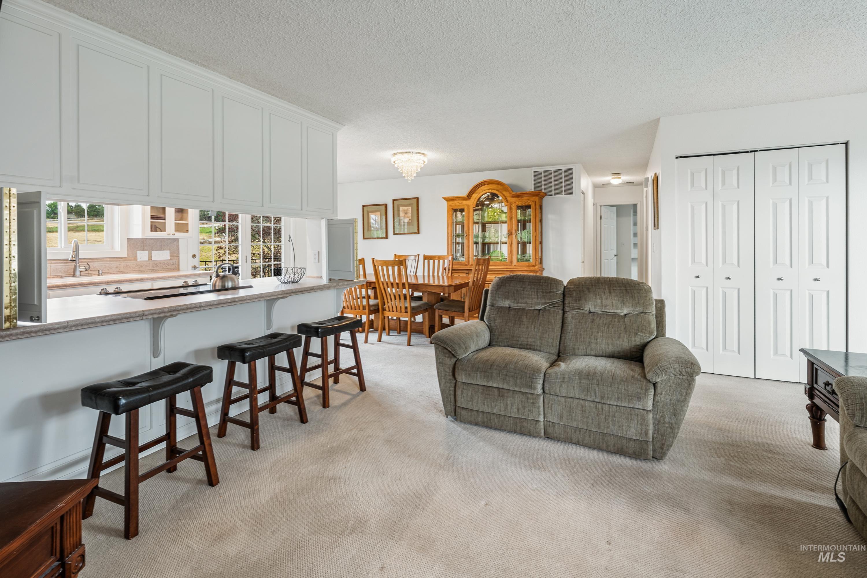 2963 Mayfair Ridge Lewiston, ID 83501 - Photo 6 of 45 Kitchen pass-through with built-in cabinetry, breakfast bar, and undermount sink