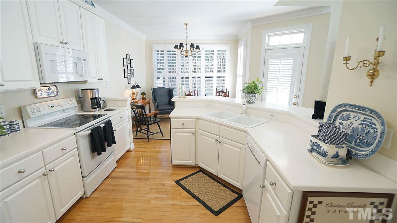 9124 Carrington Ridge Drive Raleigh, NC 27615 - Photo 4 of 24 a kitchen with a white cabinets and window