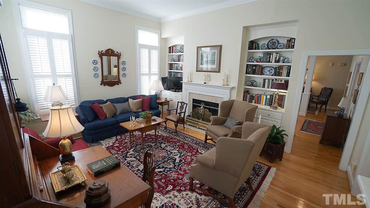 9124 Carrington Ridge Drive Raleigh, NC 27615 - Photo 6 of 24 a living room with furniture and a book shelf