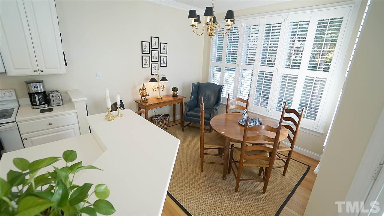 9124 Carrington Ridge Drive Raleigh, NC 27615 - Photo 9 of 24 a dining room filled chandelier and wooden floor
