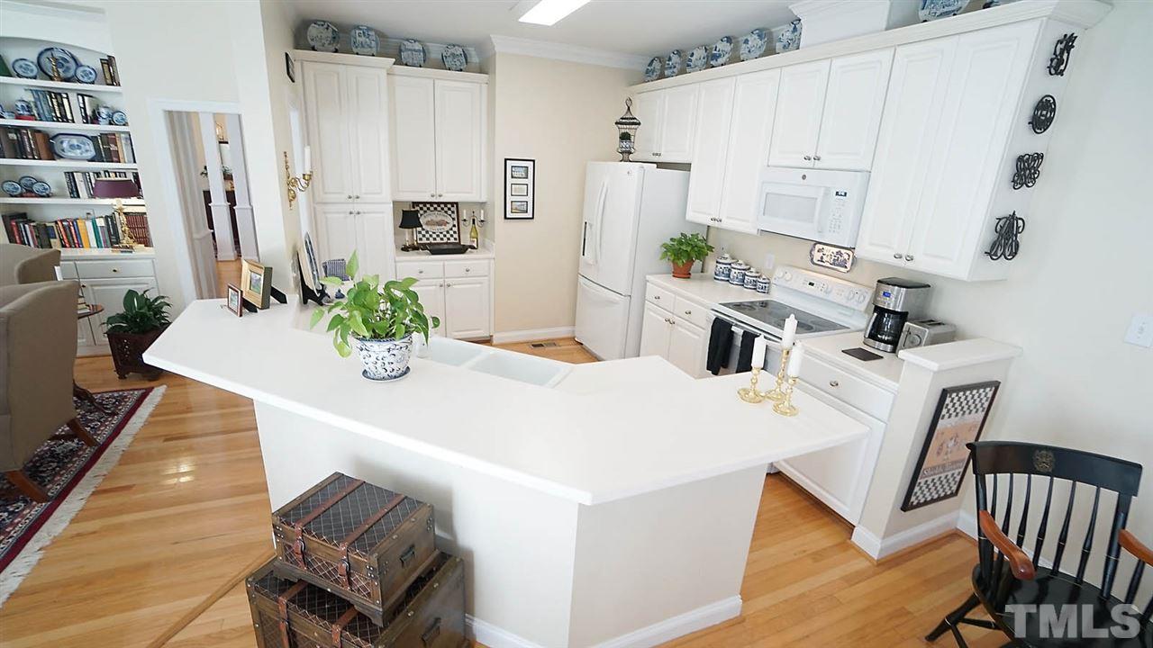9124 Carrington Ridge Drive Raleigh, NC 27615 - Photo 10 of 24 a dining room with furniture and wooden floor