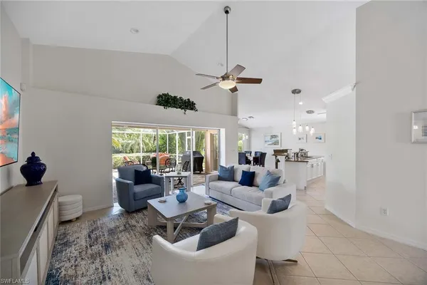 a living room with furniture a large window and a table