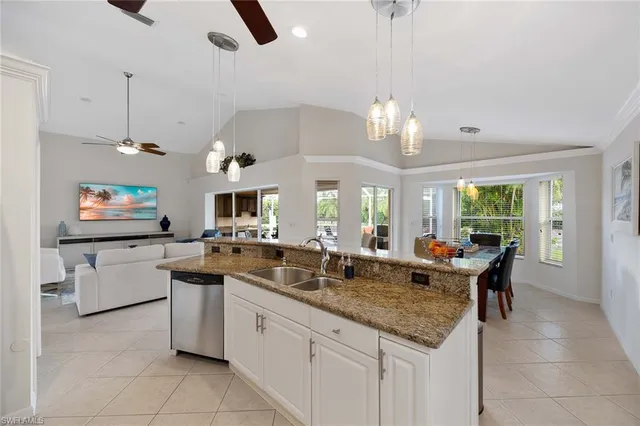 a kitchen with counter top space appliances and windows