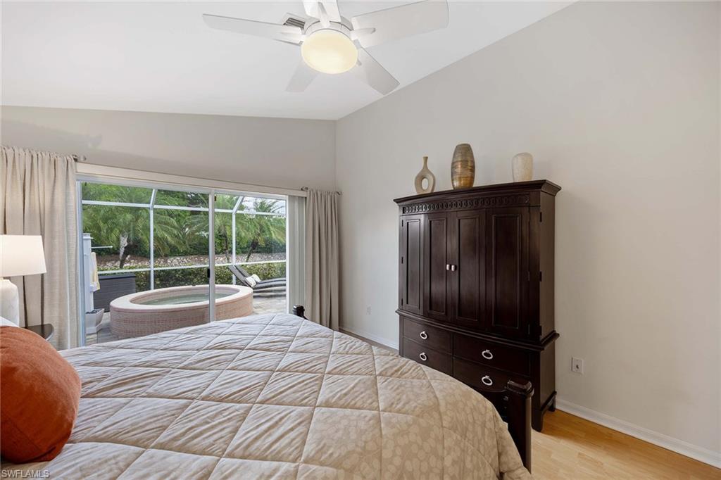 8468 Indian Wells Way Naples, FL 34113 - Photo 19 of 40 a bedroom with a bed and a window