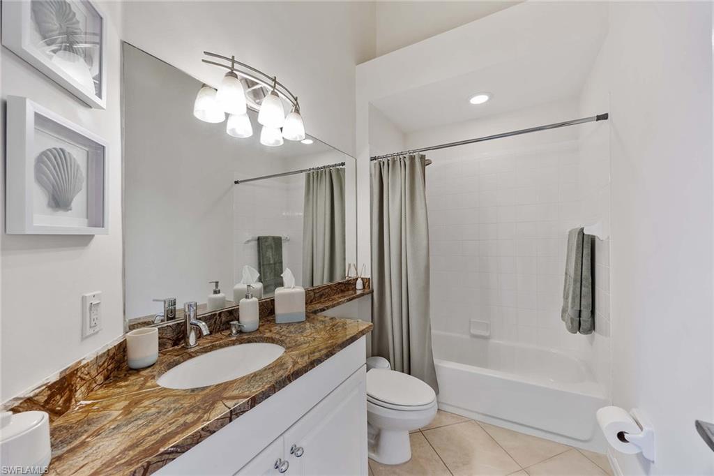 8468 Indian Wells Way Naples, FL 34113 - Photo 25 of 40 a bathroom with a granite countertop sink and a mirror