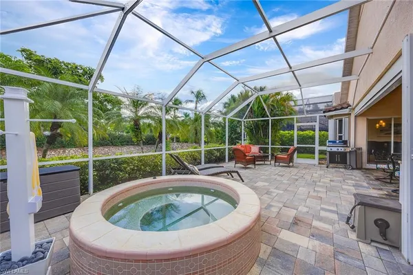 a view of a swimming pool with a patio and a backyard