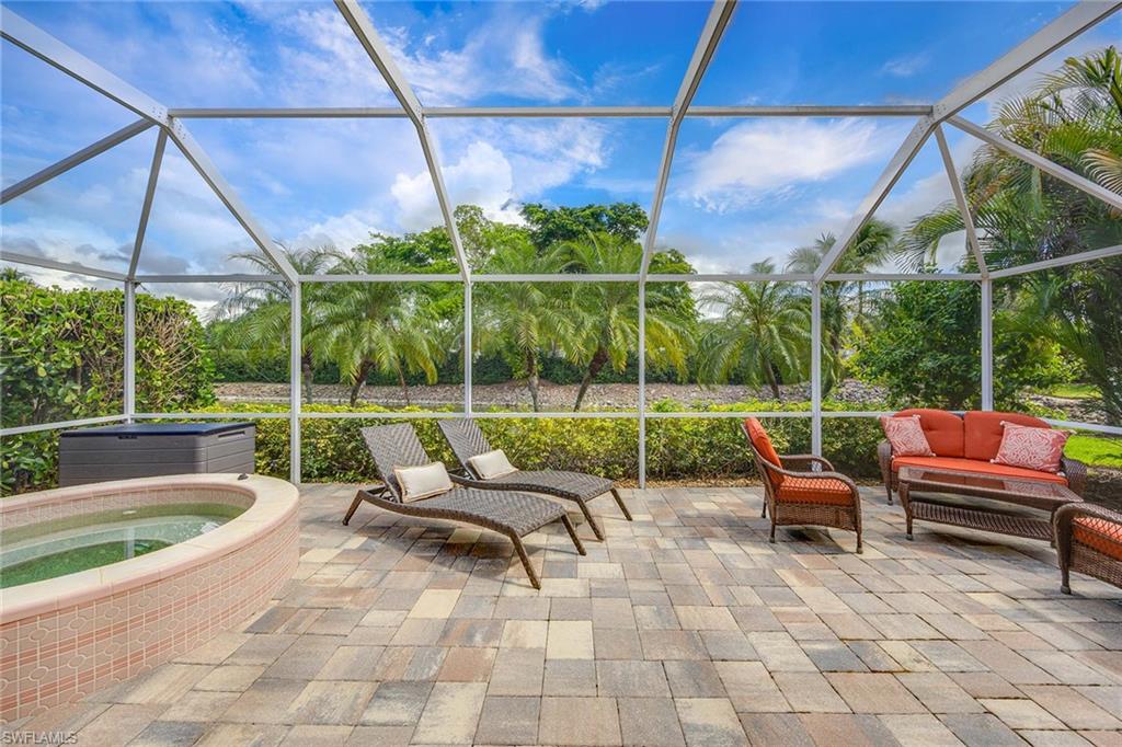 8468 Indian Wells Way Naples, FL 34113 - Photo 31 of 40 a view of a patio with a table and chairs