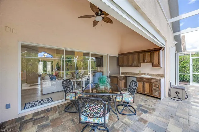 a living room with fireplace furniture and a floor to ceiling window