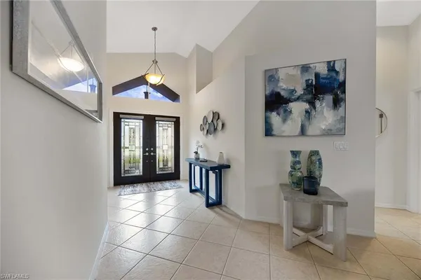 a view of a hallway with workspace and a window