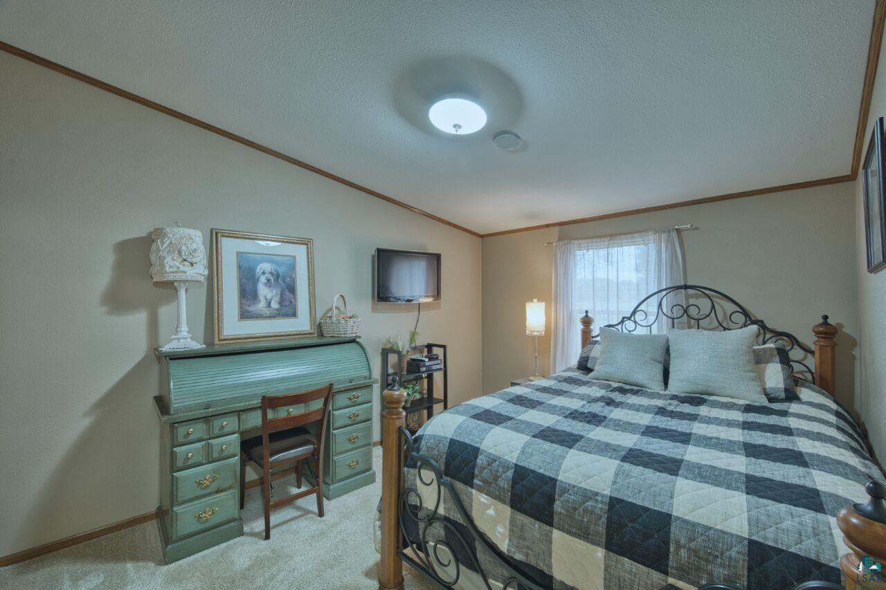 3360 North Leighton Road Hibbing, MN 55746 - Photo 27 of 60 Bedroom with carpet, crown molding, and a textured ceiling