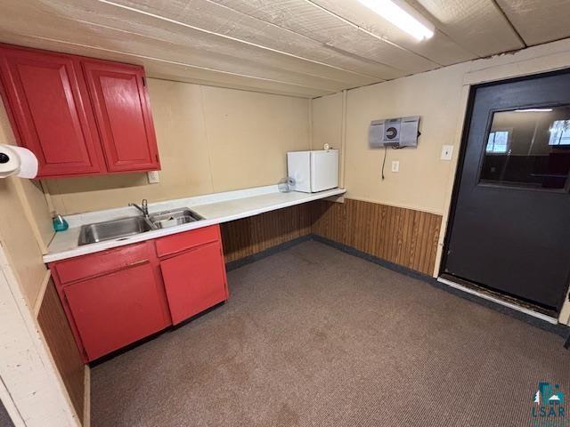 3360 North Leighton Road Hibbing, MN 55746 - Photo 34 of 60 Kitchen featuring wooden walls, light countertops, and wainscoting