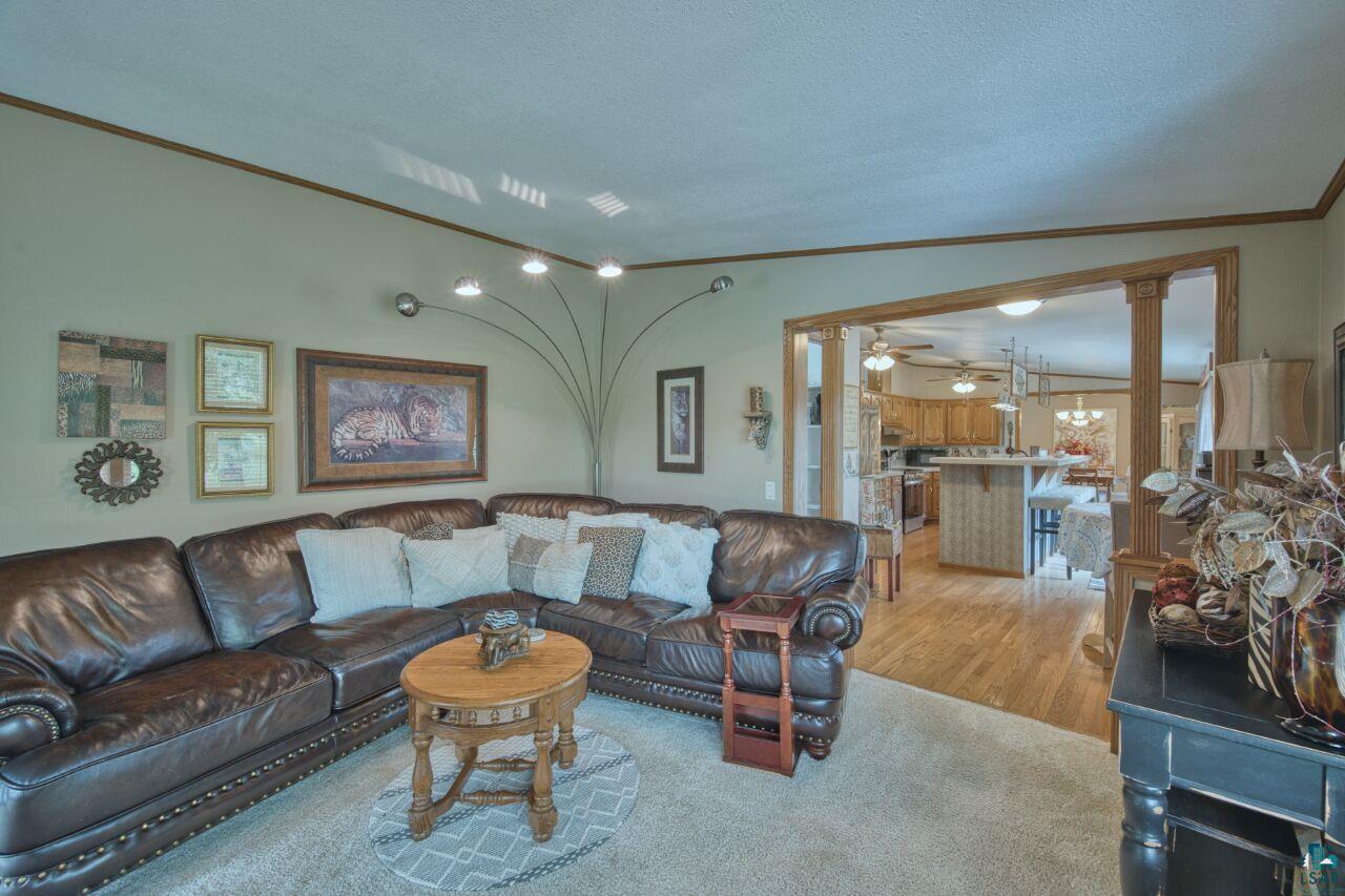 3360 North Leighton Road Hibbing, MN 55746 - Photo 4 of 60 Living area featuring ornamental molding, wood finished floors, and lofted ceiling