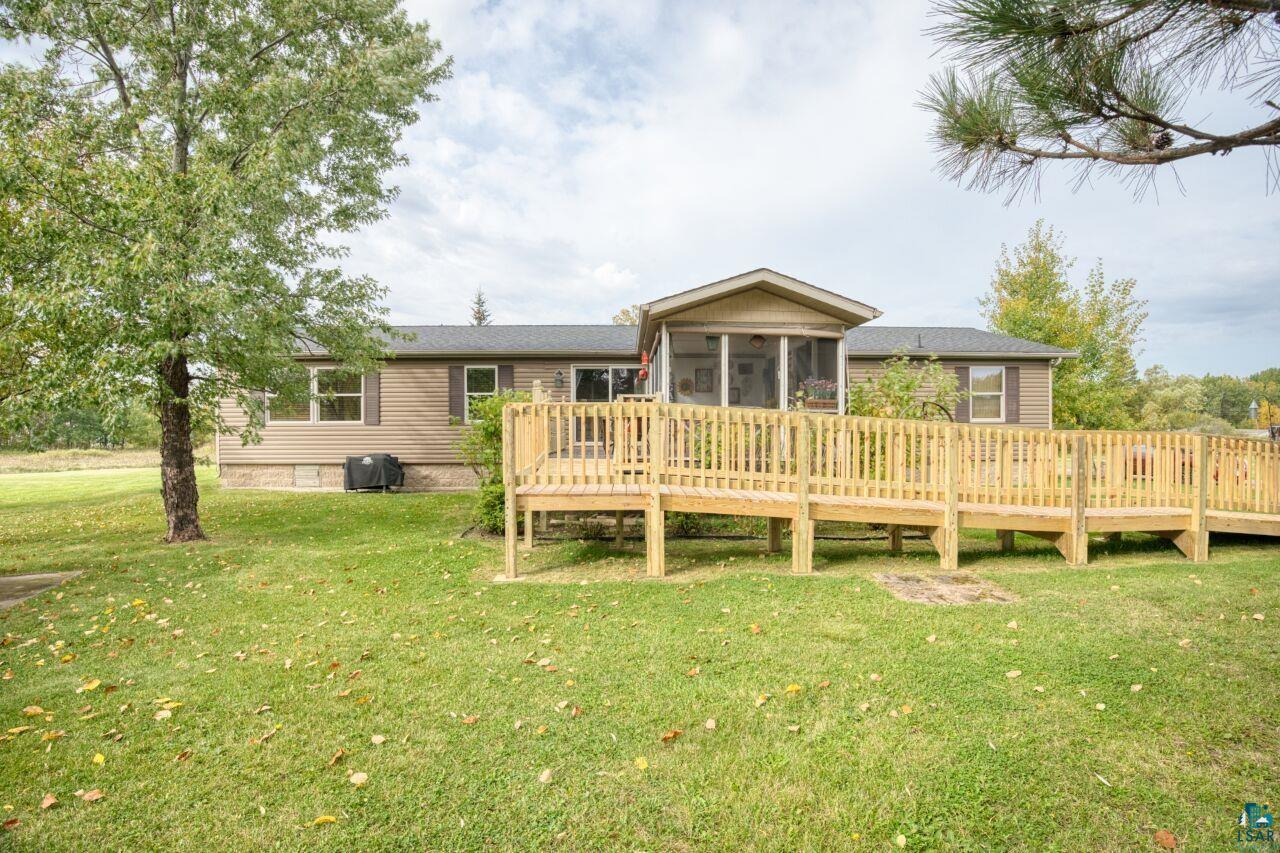3360 North Leighton Road Hibbing, MN 55746 - Photo 42 of 60 Back of property featuring a wooden deck, a sunroom, and a yard
