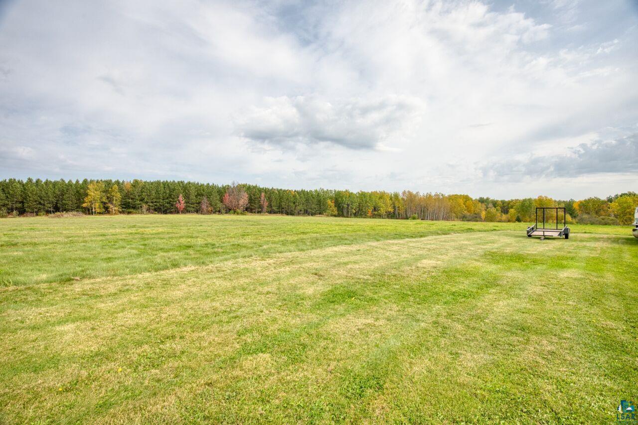 3360 North Leighton Road Hibbing, MN 55746 - Photo 50 of 60 View of green lawn featuring a forest view