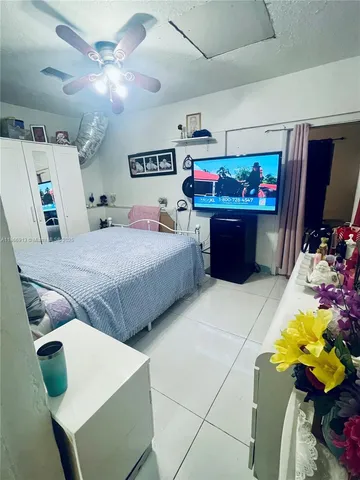 a bedroom with a bed and ceiling fan