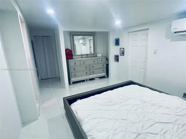 a bedroom with a bed and a mirror