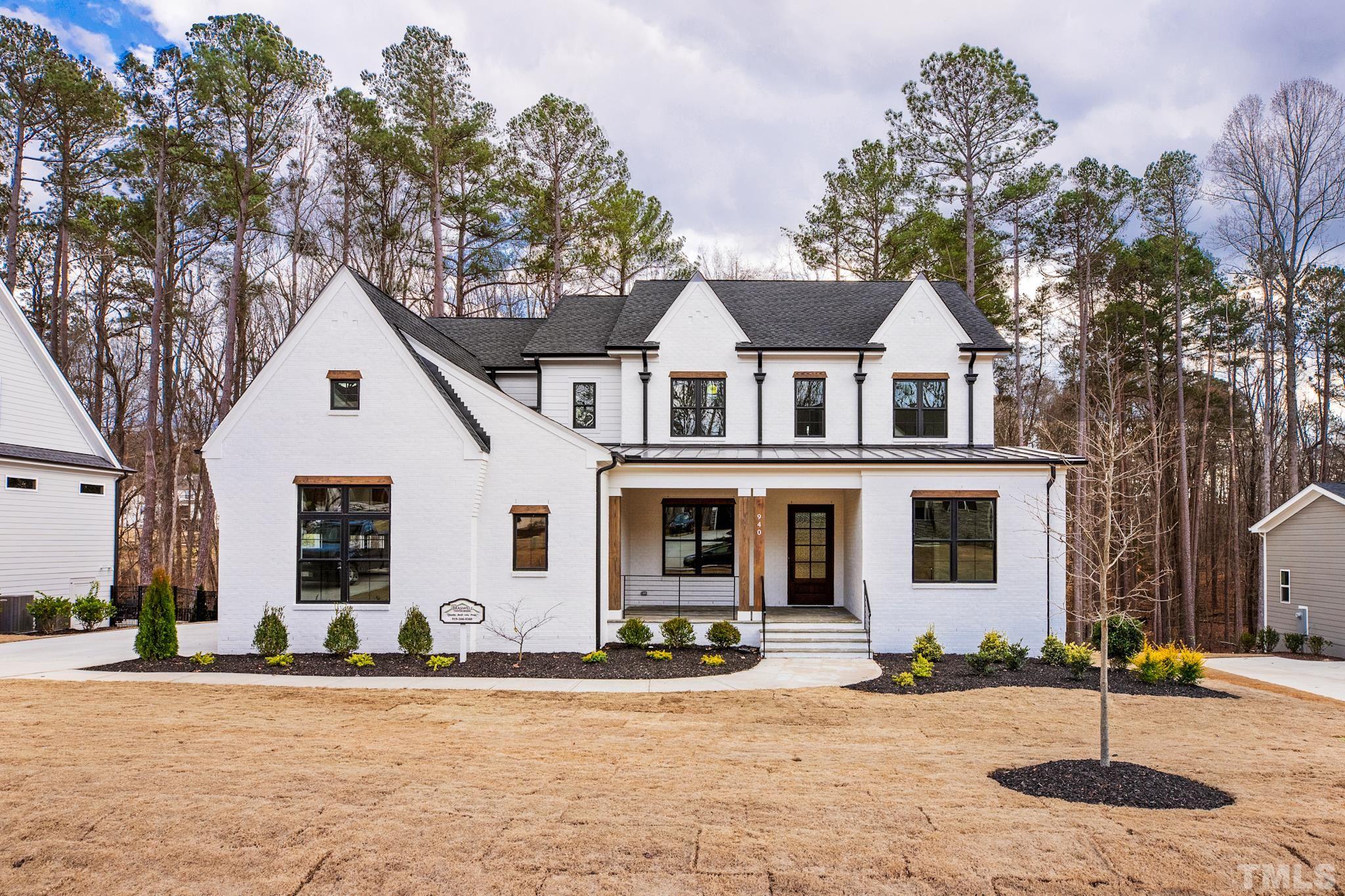 940 Harrison Ridge Road Wake Forest, NC 27587 - Photo 1 of 30 a front view of a house with garden and trees