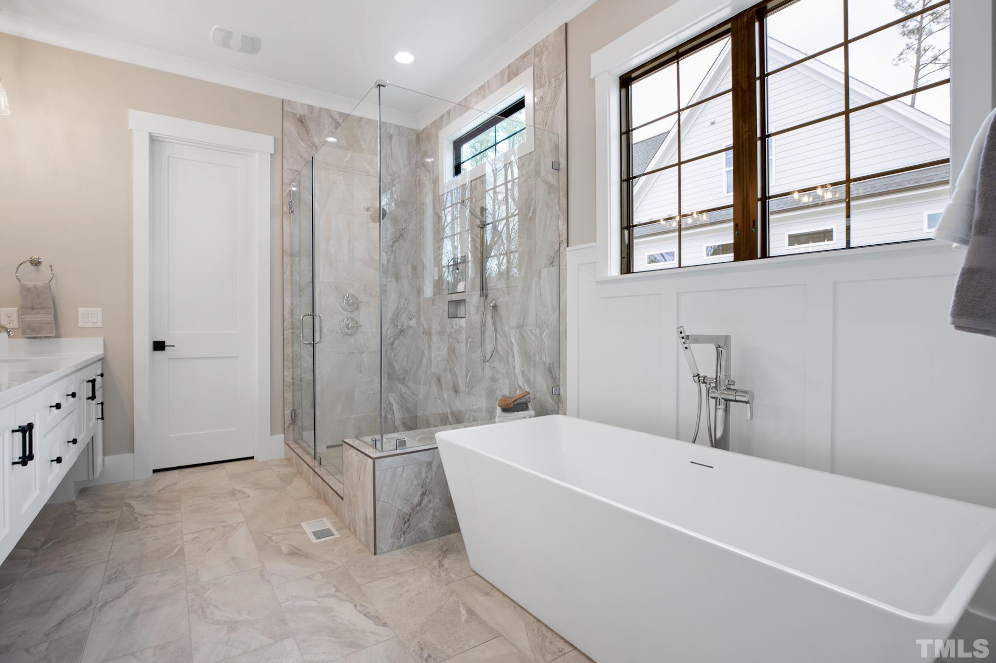 940 Harrison Ridge Road Wake Forest, NC 27587 - Photo 14 of 30 a bathroom with a bathtub and a shower