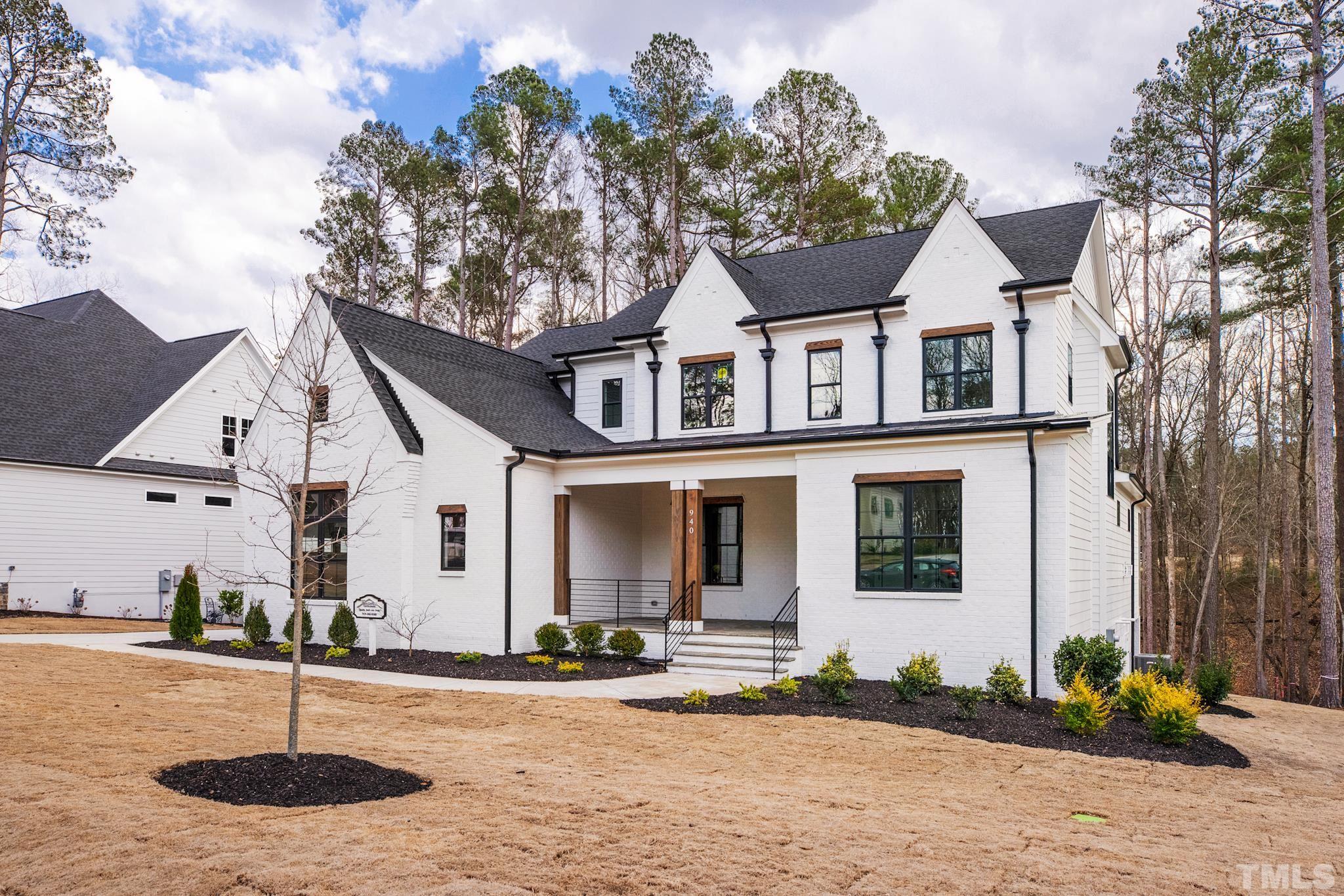 940 Harrison Ridge Road Wake Forest, NC 27587 - Photo 2 of 30 a front view of a house with garden