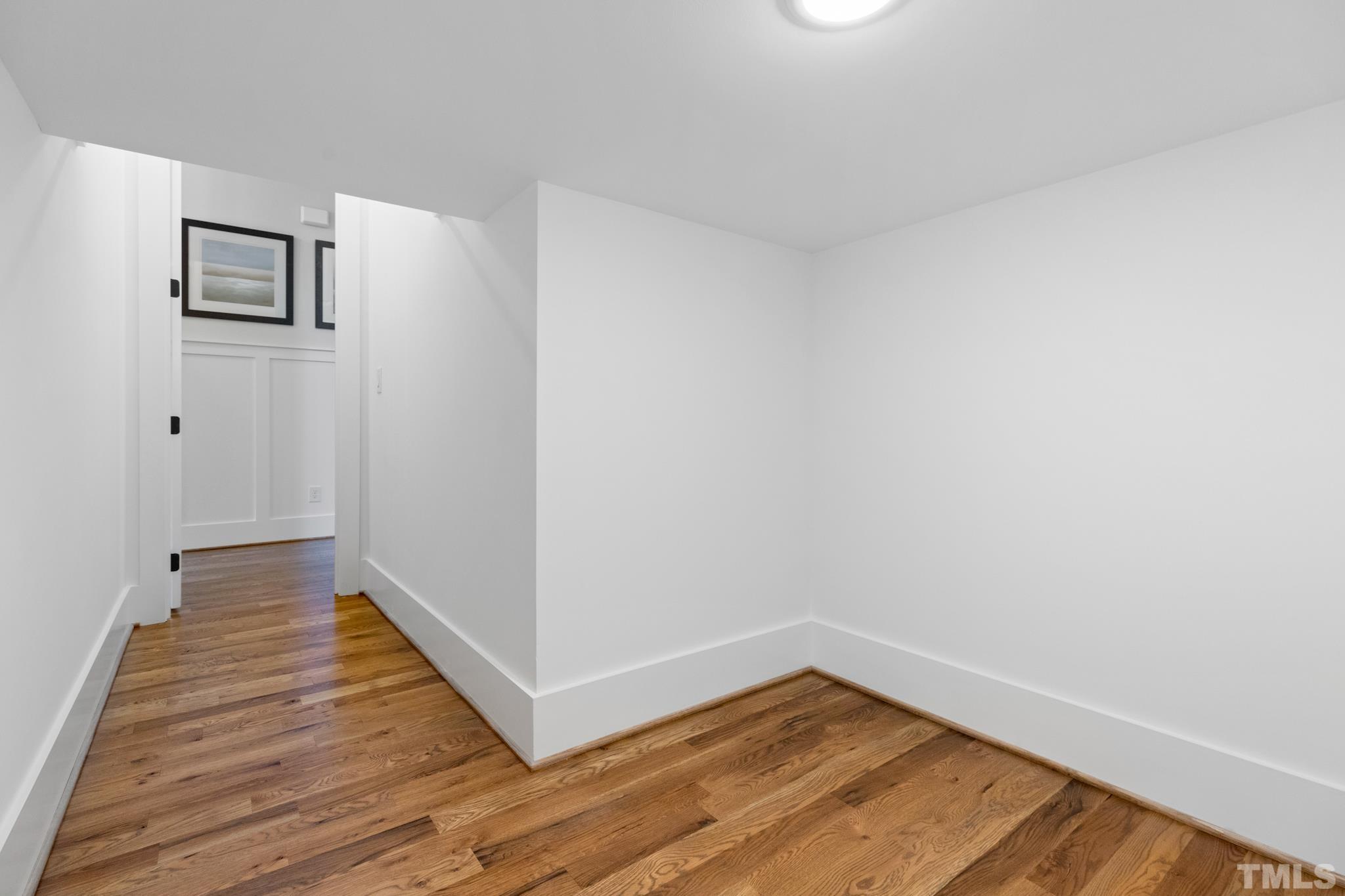 940 Harrison Ridge Road Wake Forest, NC 27587 - Photo 21 of 30 a view of an empty room with wooden floor