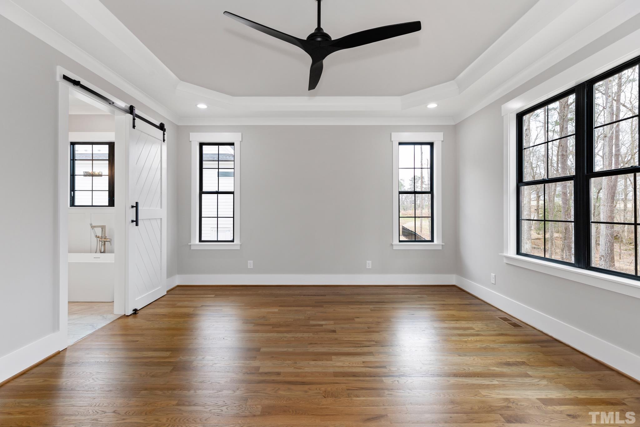 940 Harrison Ridge Road Wake Forest, NC 27587 - Photo 24 of 30 a view of an empty room with wooden floor and a window