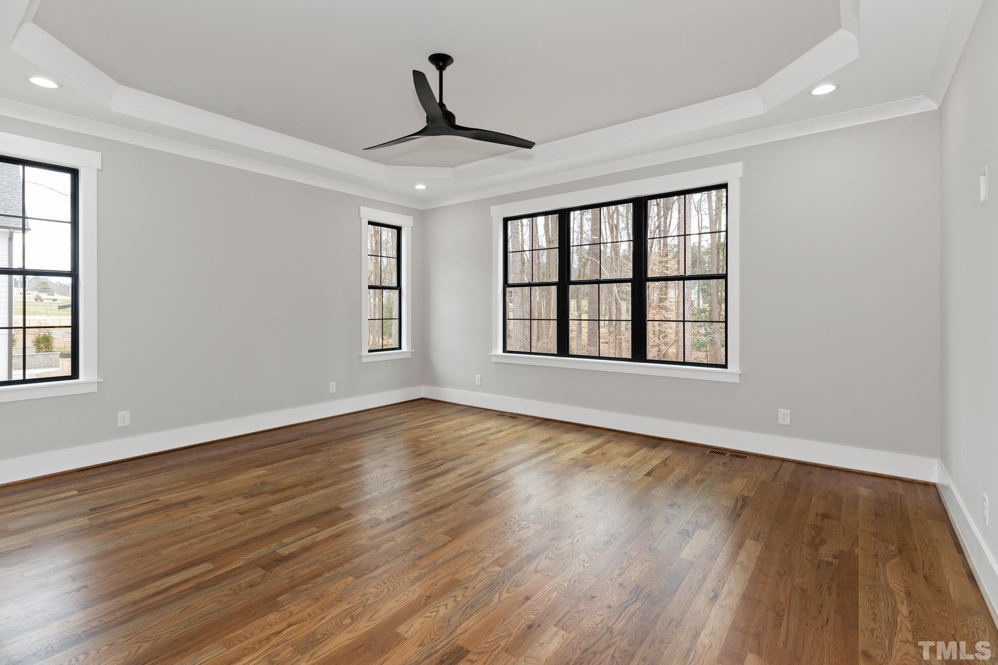 940 Harrison Ridge Road Wake Forest, NC 27587 - Photo 26 of 30 a view of an empty room with wooden floor and a window