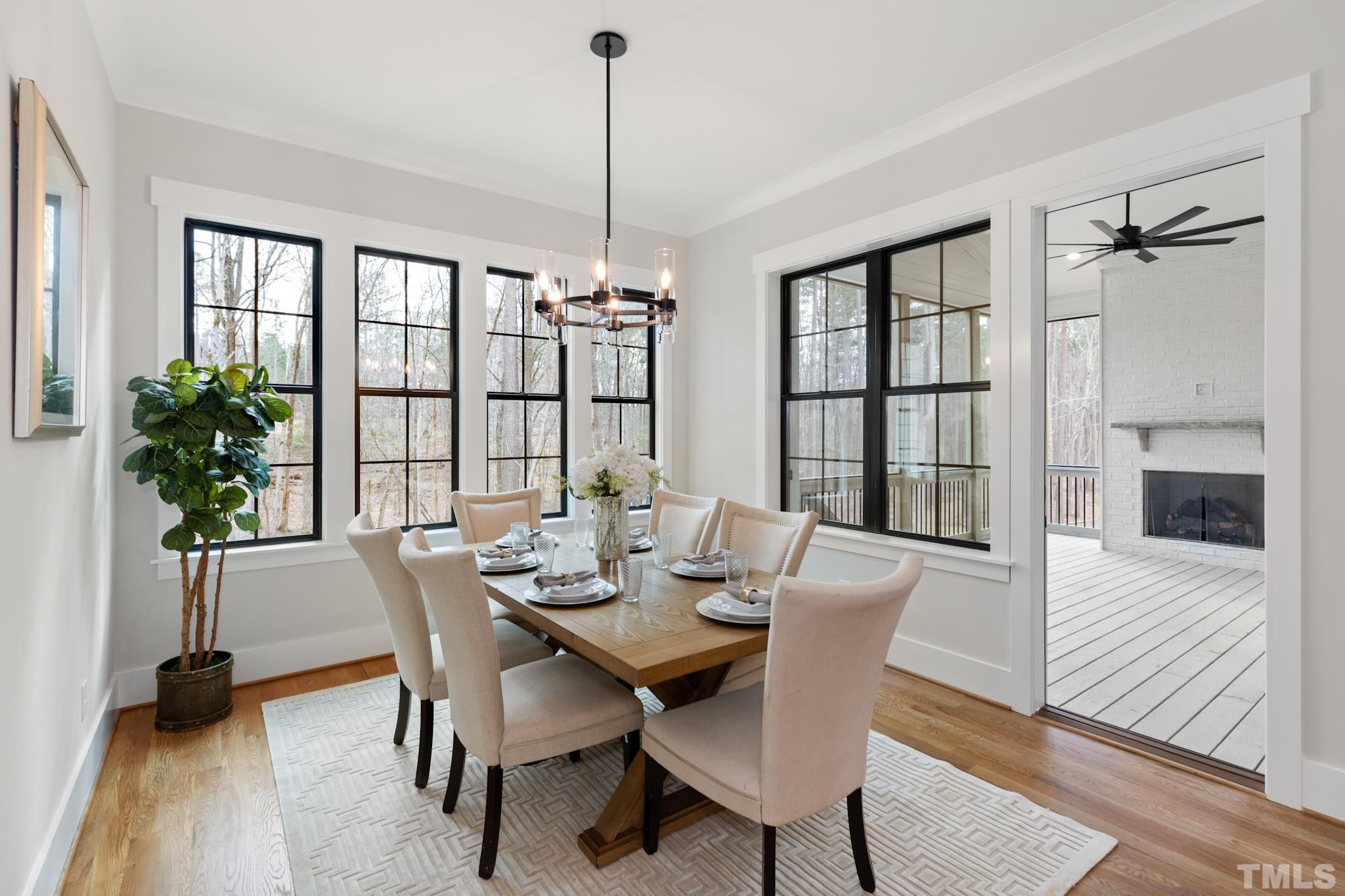 940 Harrison Ridge Road Wake Forest, NC 27587 - Photo 10 of 30 a view of a dining room with furniture window and wooden floor
