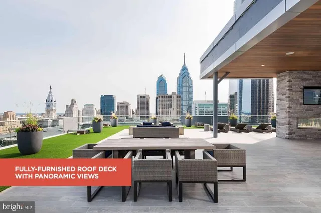 a roof deck with couches and a fireplace