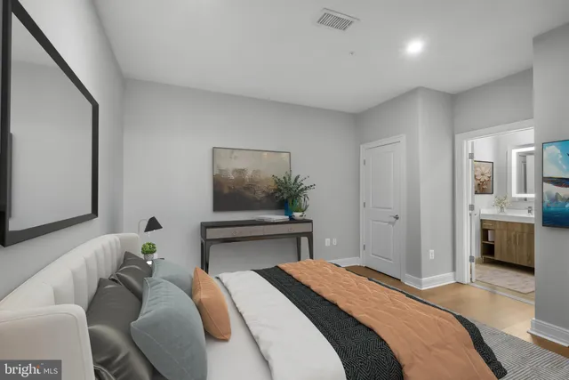 a bedroom with a bed and a chandelier