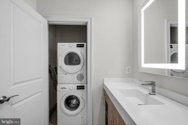 a utility room with sink dryer and washer