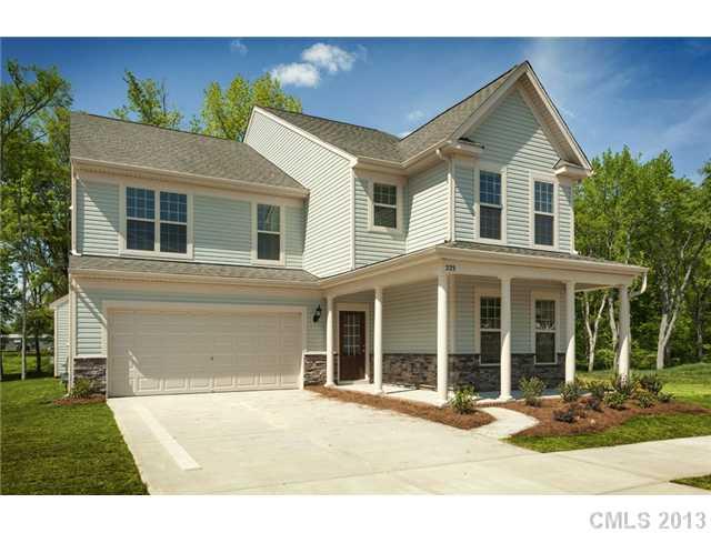 1437 Ridgehaven Road, Unit 160 Waxhaw, NC 28173 - Photo 3 of 10 a front view of a house with a yard and seating space