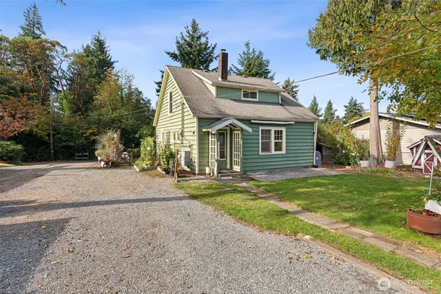 a view of a house with a yard and tree s
