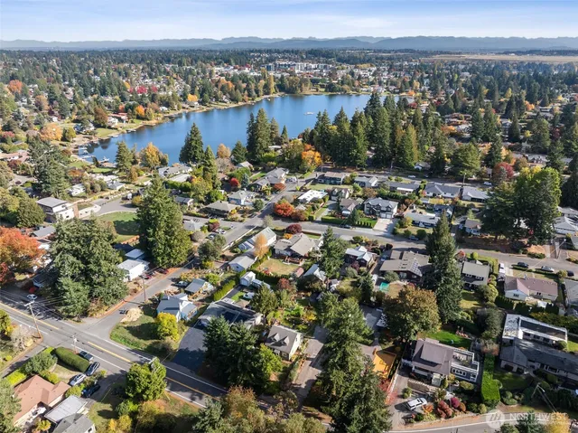 an aerial view of multiple houses with yard