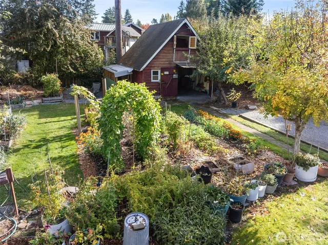 an aerial view of a house with a yard and garden