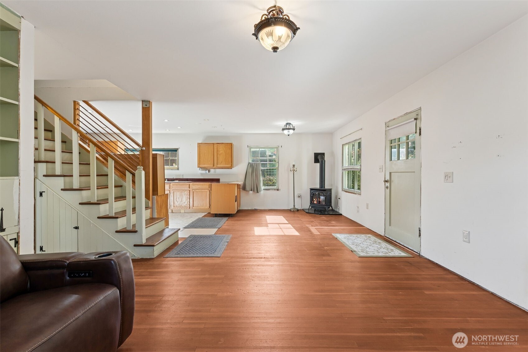 15620 21st Avenue Southwest Burien, WA 98166 - Photo 4 of 38 a view of an empty room with wooden floor and a window