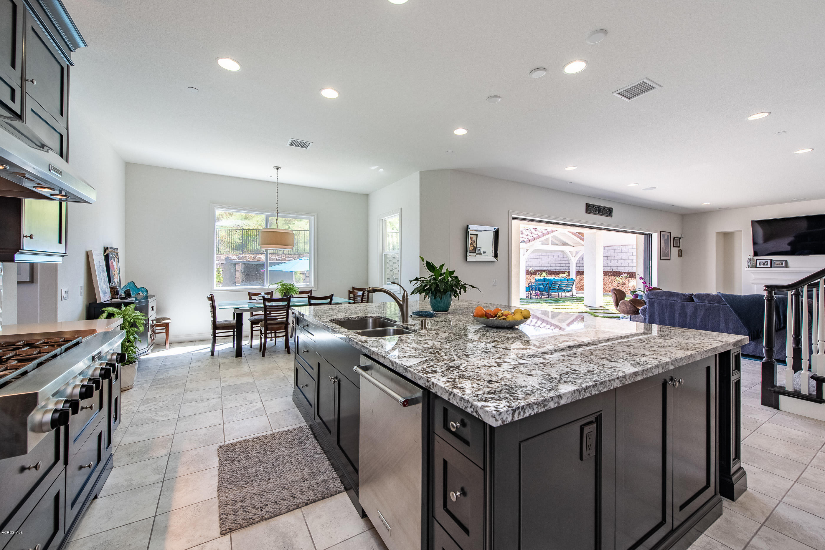 11276 Crenshaw Street Moorpark, CA 93021 - Photo 15 of 52 a kitchen with granite countertop stove top oven dining table and chairs
