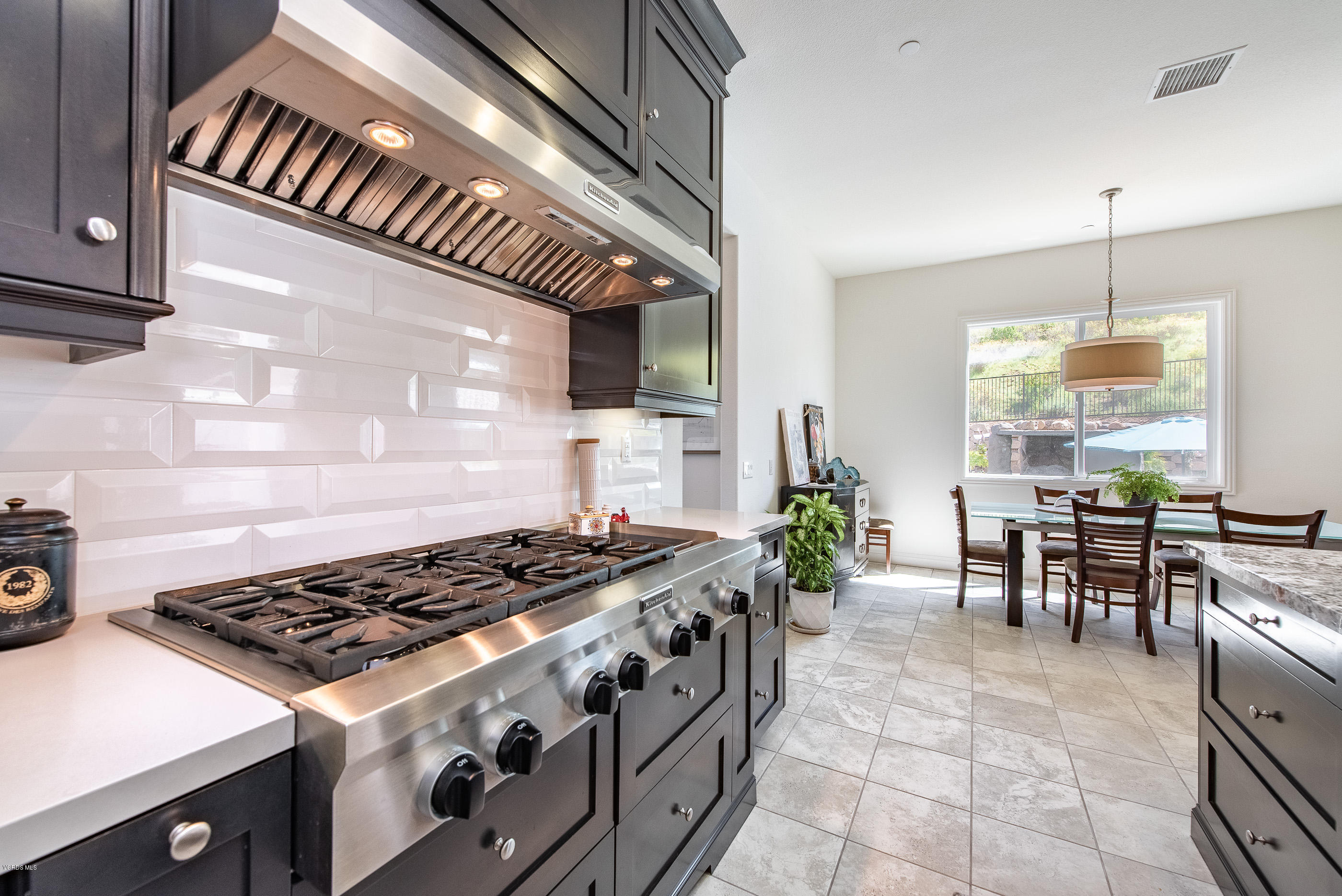 11276 Crenshaw Street Moorpark, CA 93021 - Photo 16 of 52 a kitchen with a stove a table and chairs in it