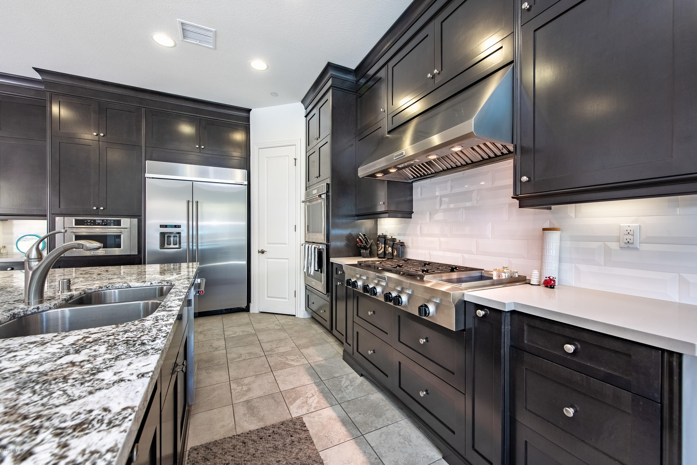 11276 Crenshaw Street Moorpark, CA 93021 - Photo 17 of 52 a kitchen with stainless steel appliances granite countertop a sink stove and refrigerator